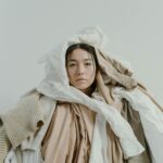 A woman covered in cluttered asset data